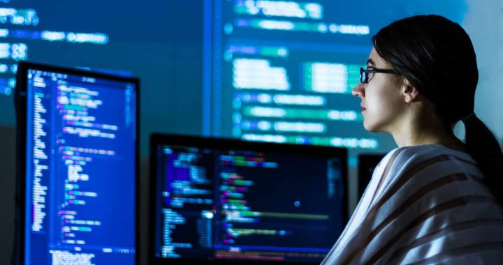 Woman looking at complex data on a computer