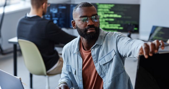 Man touching computer monitor