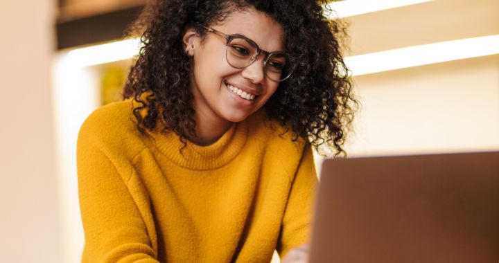 Woman smiling while working on a computer