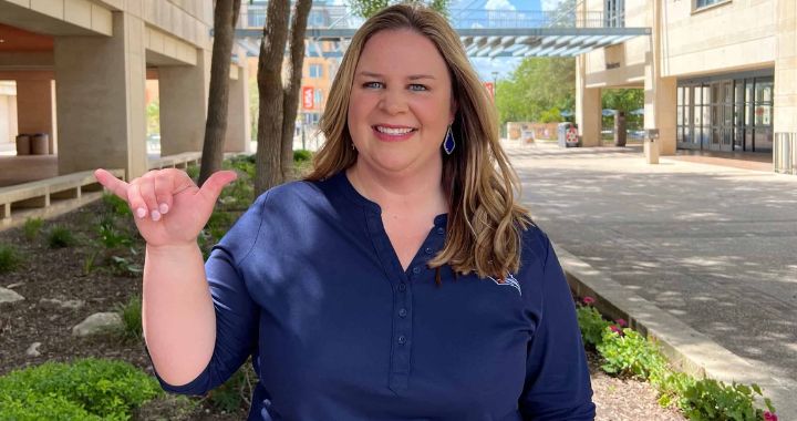 Stephanie Stout holding up "Roadrunner" hand sign