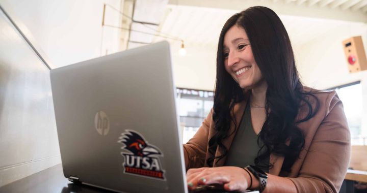 UTSA Online student working on a computer